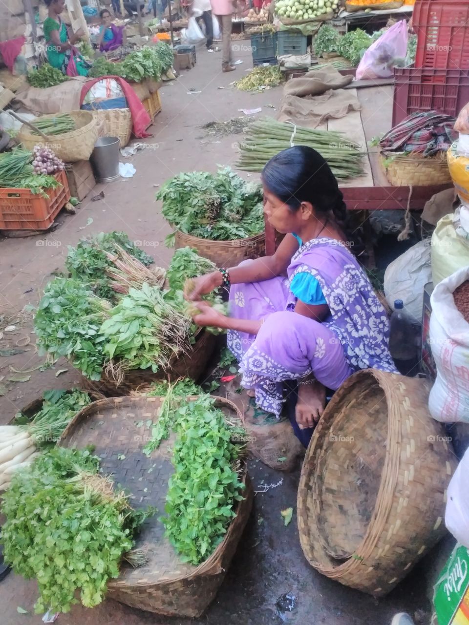 Woman selling vegetables in market