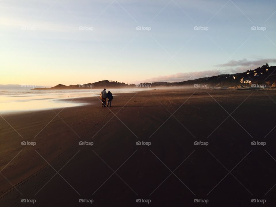 Beautiful elderly couple strolling on Newport Beach, Oregon