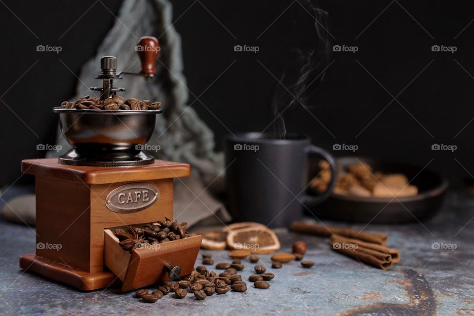 still life with antique coffee grinder and coffee beans