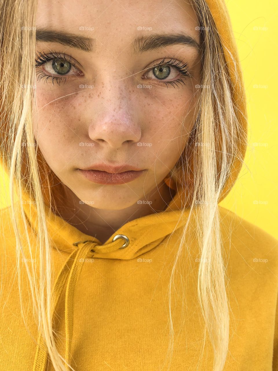 Beautiful teenage girl in bright yellow