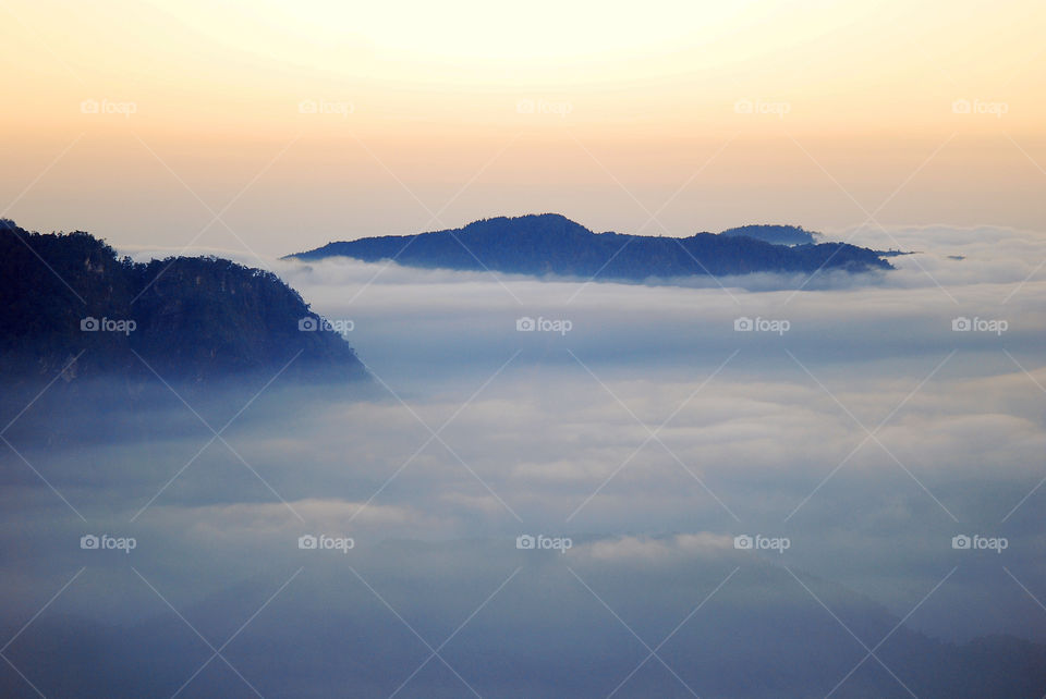 Scenic view of clouds over mountains