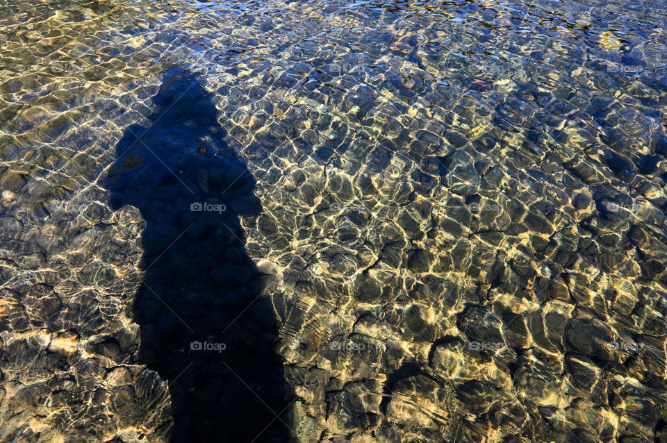 Shadows on water with tiny ripples shapes