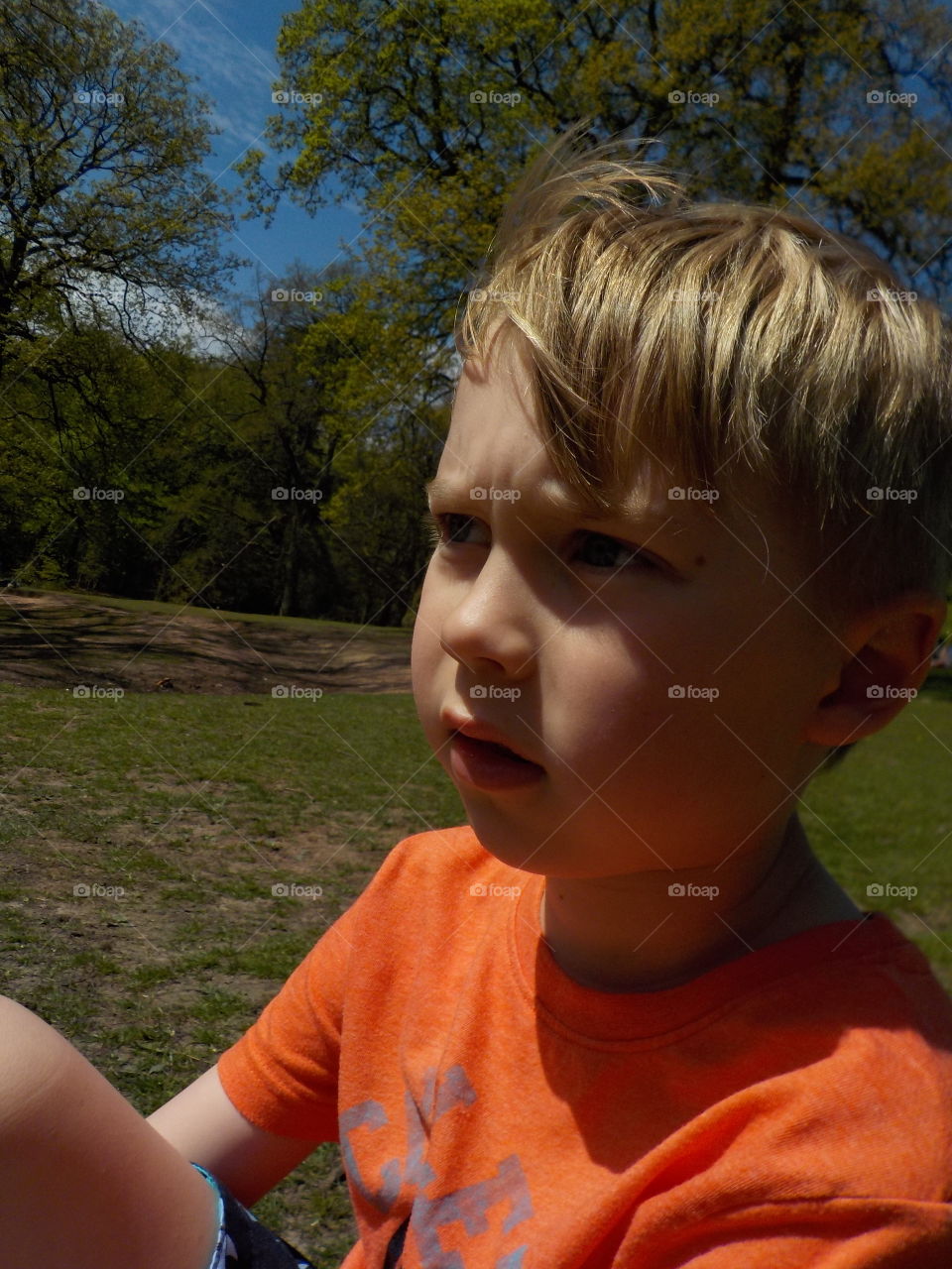 Close-up of boy sitting on grass