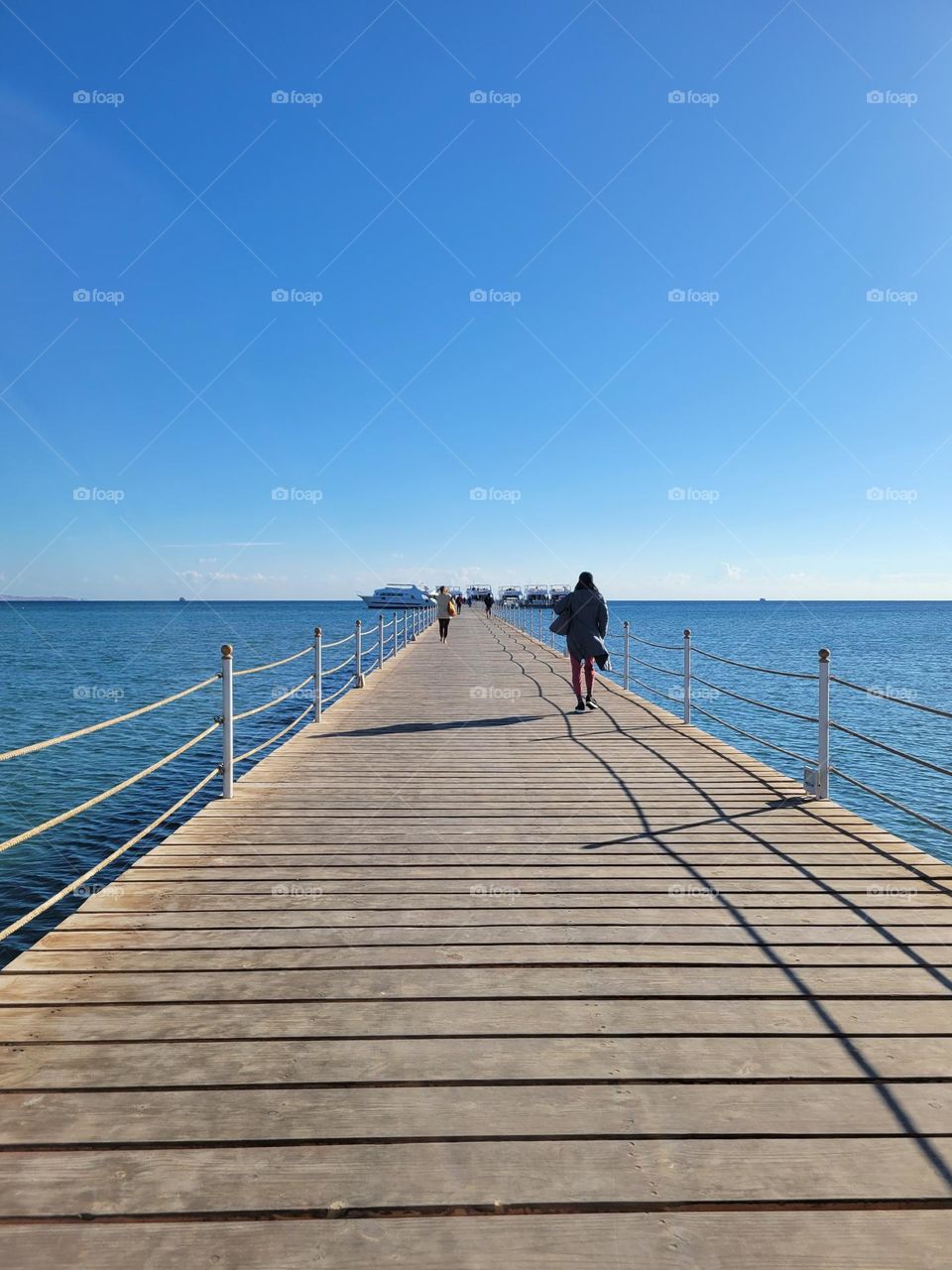 cloudless sunny day - footbridge at pier to boat for diving and snorkeling at Hurghada Egypt