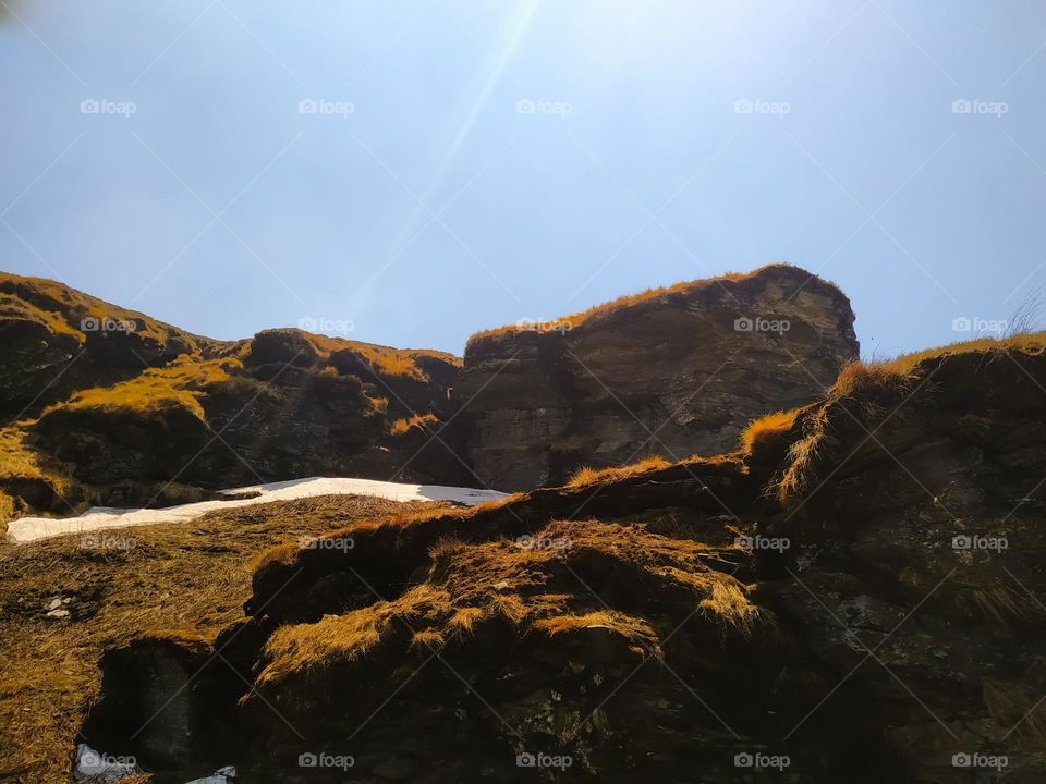 A view of rocks in the mountains with blue sky