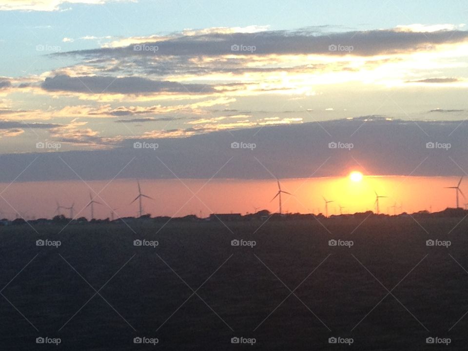 Wind power. Wind turbines at sunset