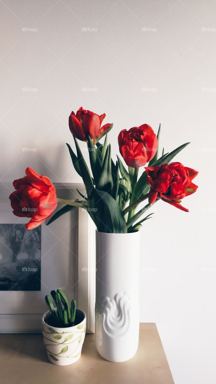 Ceramic vase with red tulips