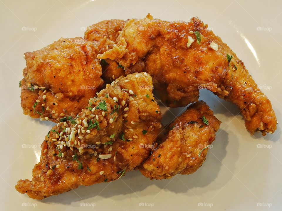 Spicy Fried Chicken. Korean Fried Chicken With Green Onions And Sesame Seeds
