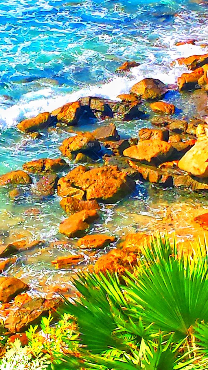 Crashing Waves. Crashing waves against the red rock cliffs in Laguna Beach.