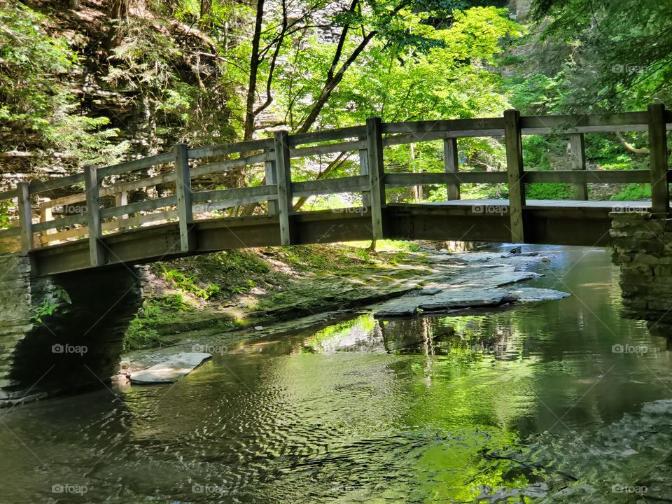 an old wooden bridge stands the test of time and travelers seeking nature's beauty