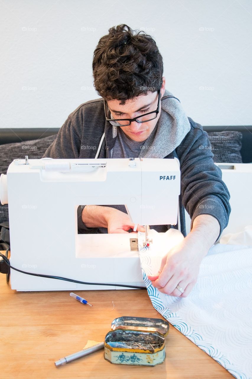 Man learning to sew