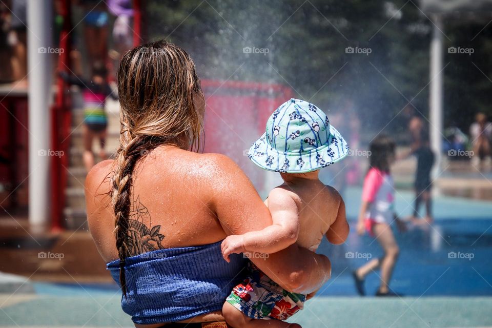 Mother and baby at a slash pad on a hot summer day