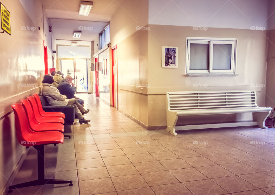 Patients In Doctors Waiting Room
