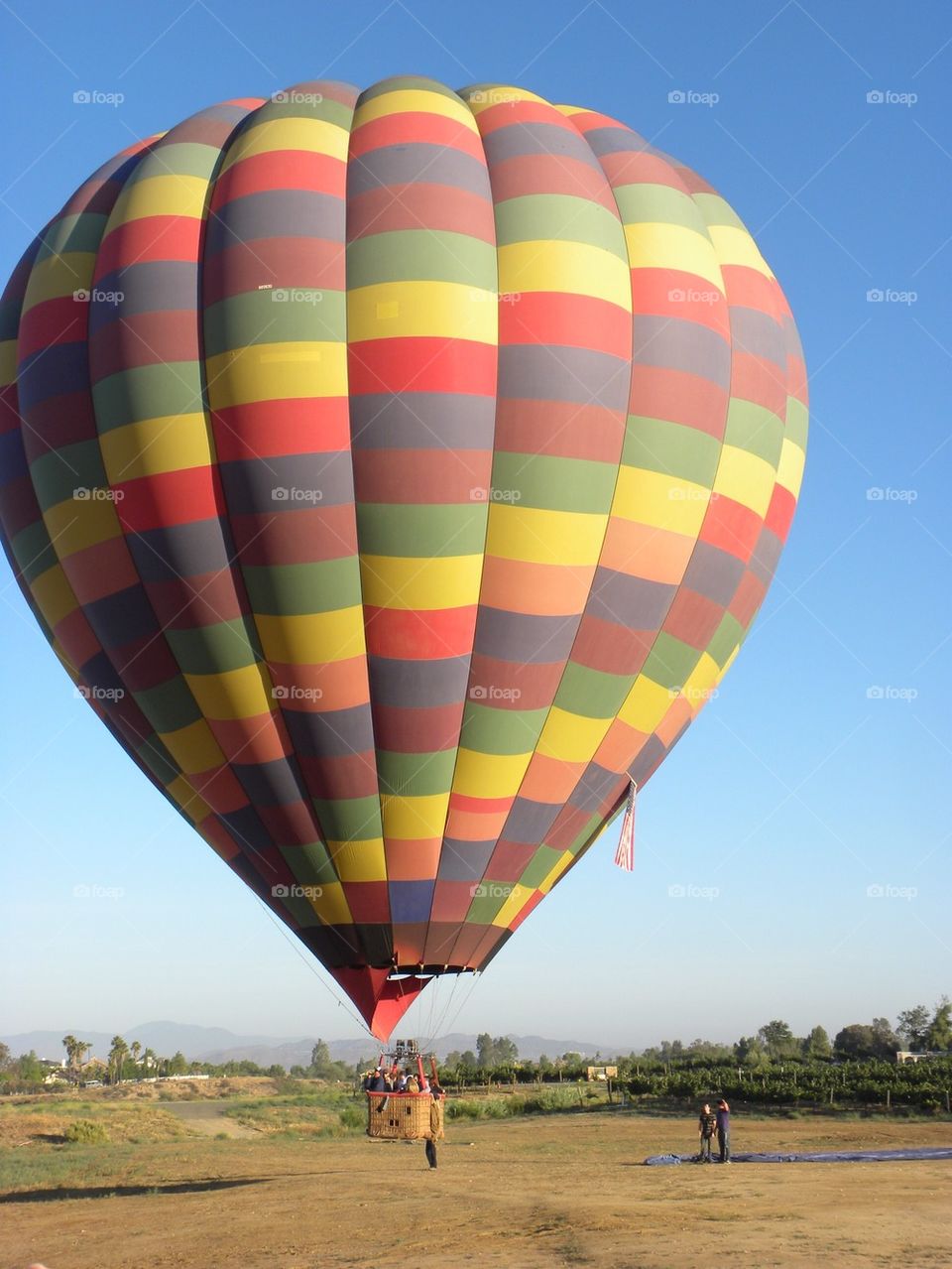 Colorful hot air balloon flying over the landscape