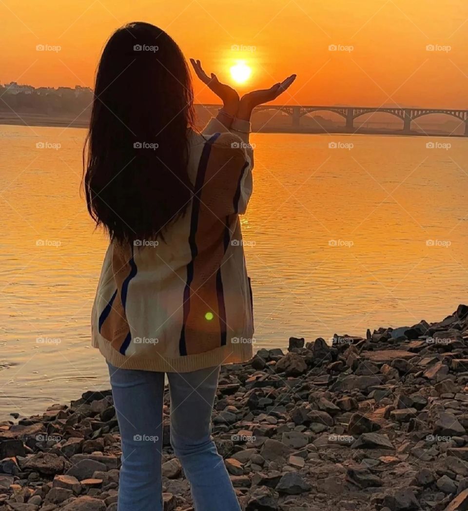 Sunset Girl holding Sunset