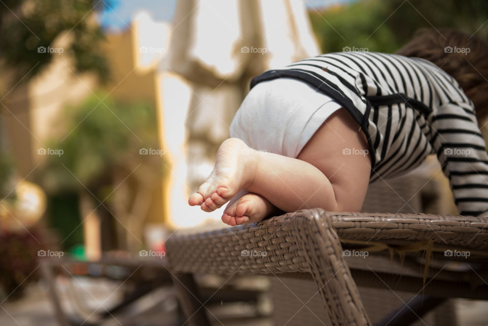 Close-up of a baby crawling on seat