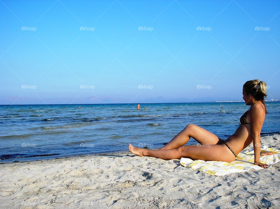 A girl in bikini on the seacoast