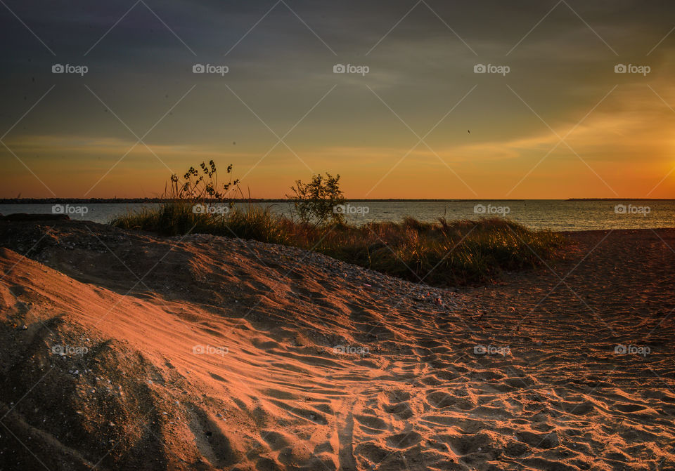 Sand dunes illuminated by sunrise in Lake Michigan in Milwaukee, Wisconsin 