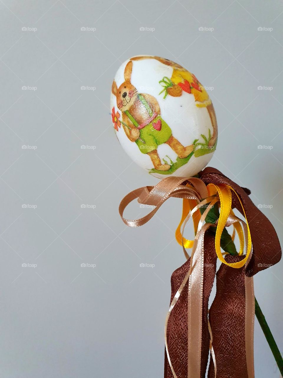 colorful plastic easter egg with easter bunny  on a stick