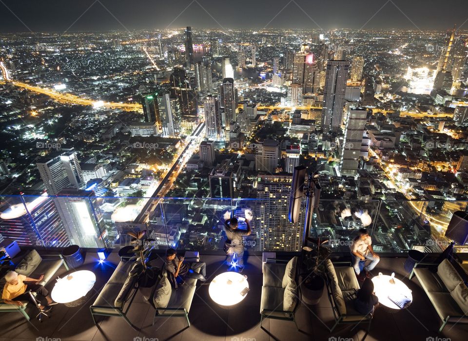 Bangkok/Thailand-May 04 2019:Night light over capital city from bird eyes view , Mahanakorn building roof top 