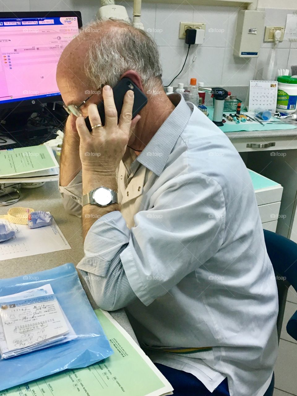 A doctor talking on a smartphone