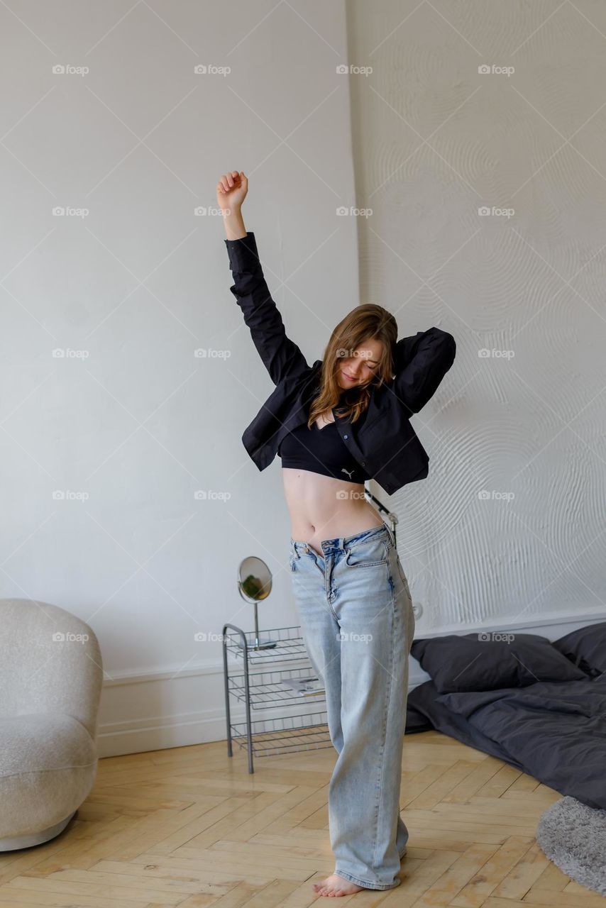 Beautiful young girl in jeans in full growth