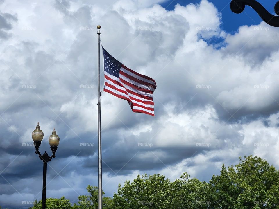 American flag waving in the wind on a cloudy day in Oregon