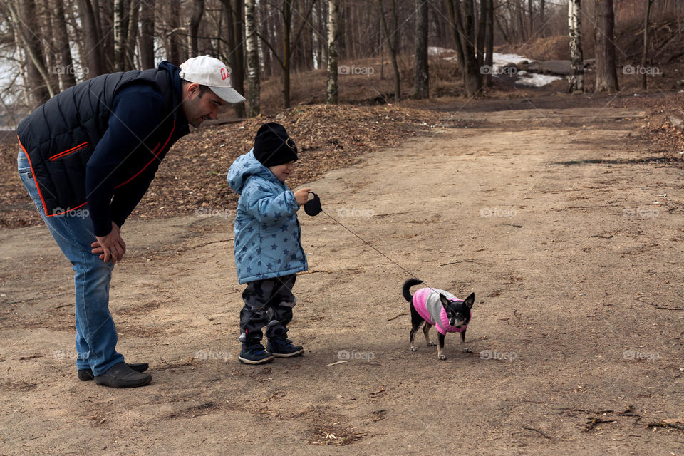 the kid learns to walk the dog