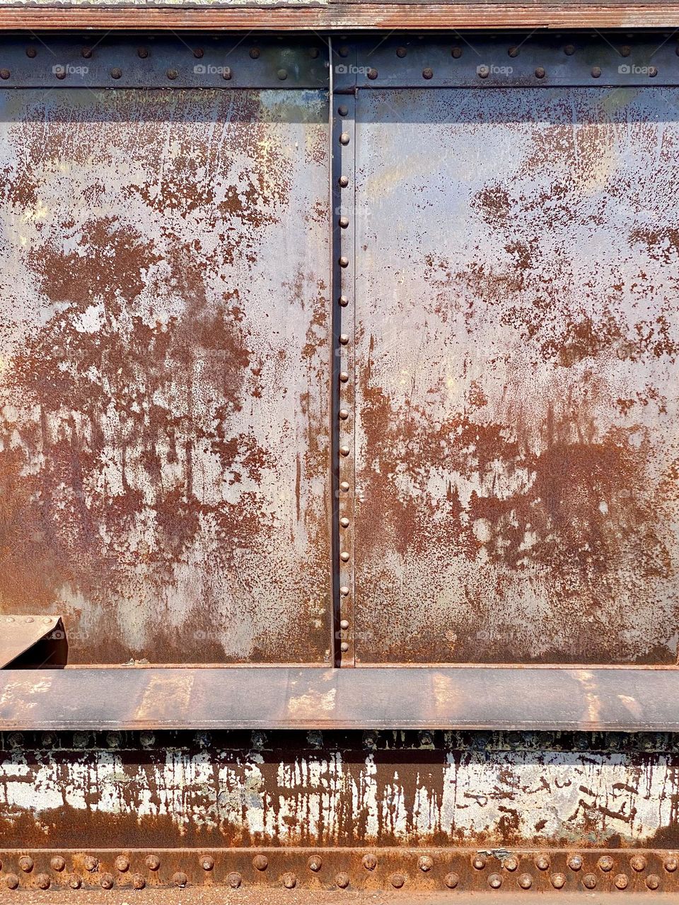 Rusty metal siding on a bridge