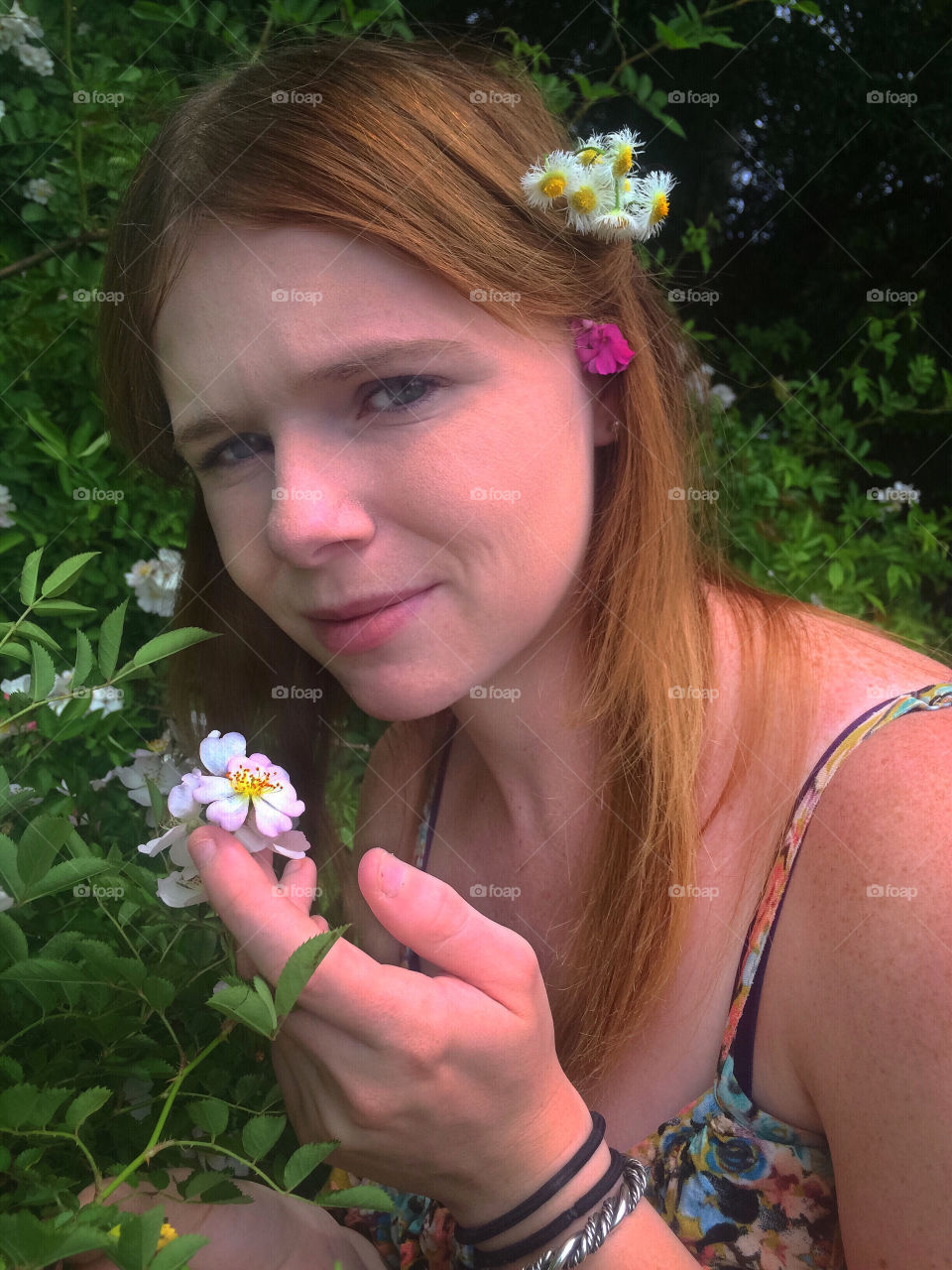 Portrait of woman holding flower
