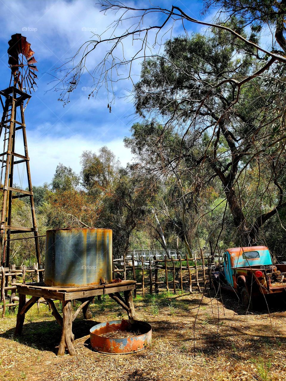 Weather and time have taken their toll on a windmill and truck that are now rusted and out of order