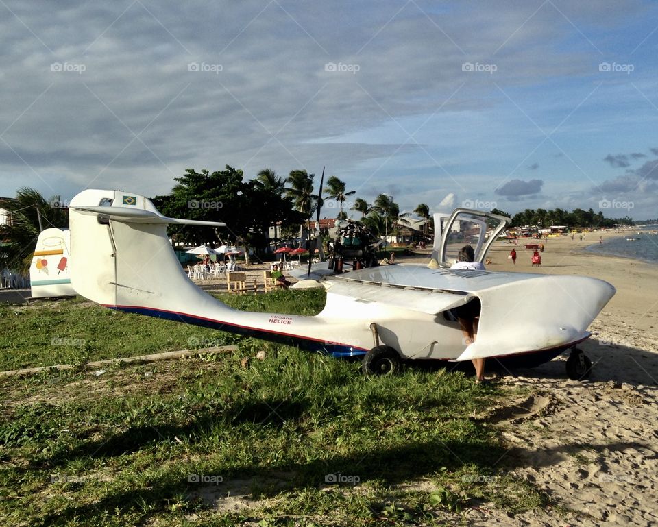 a two-passenger model airplane that lands on the sea and goes from beach A to beach B