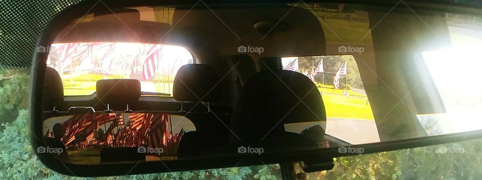 looking forward to look back through the use of my rear-view mirror beautiful Flags flowing in the breeze