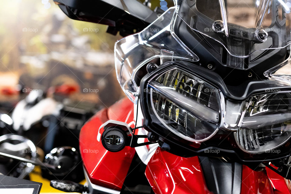 Close up of the front of a brand new enduro motorcycle, soft focus, abstract bakground.