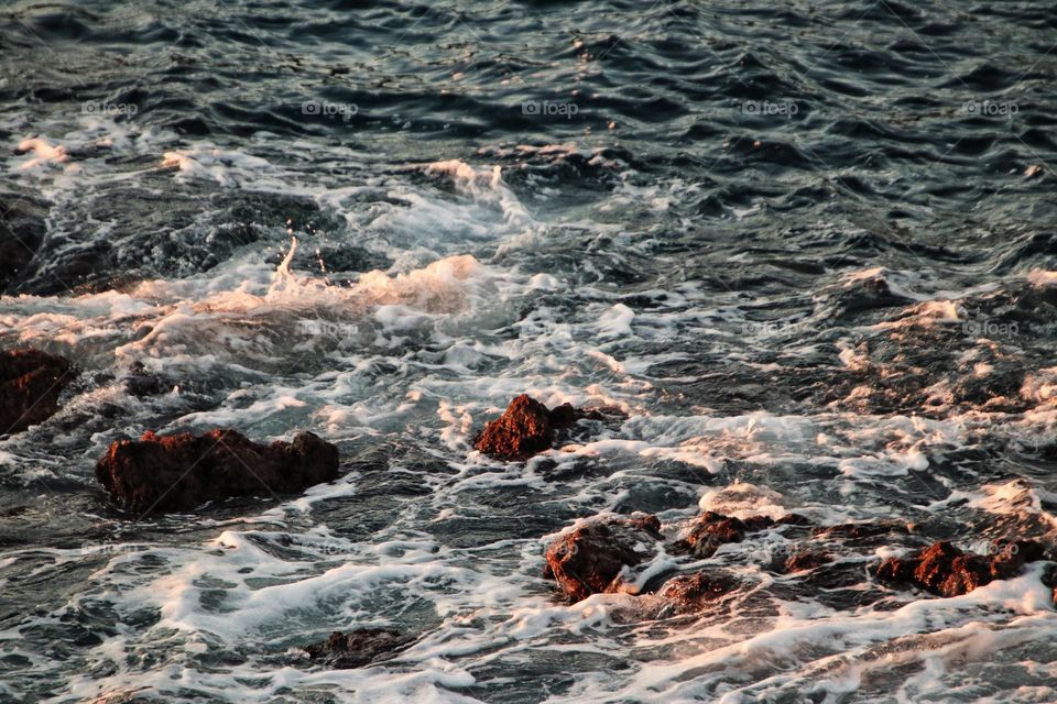 View of the wavy rocky atlantic ocean at sunrise 