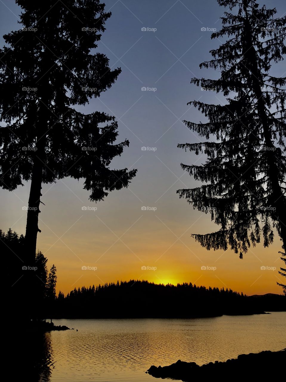 The setting sun is above the dam