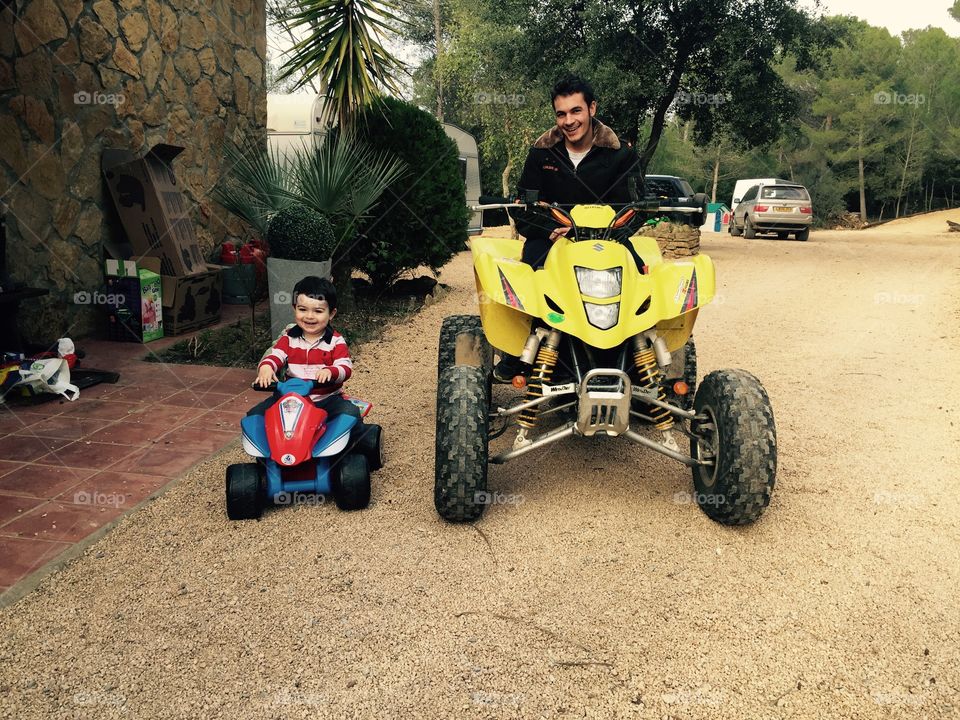Father and son riding four wheeler