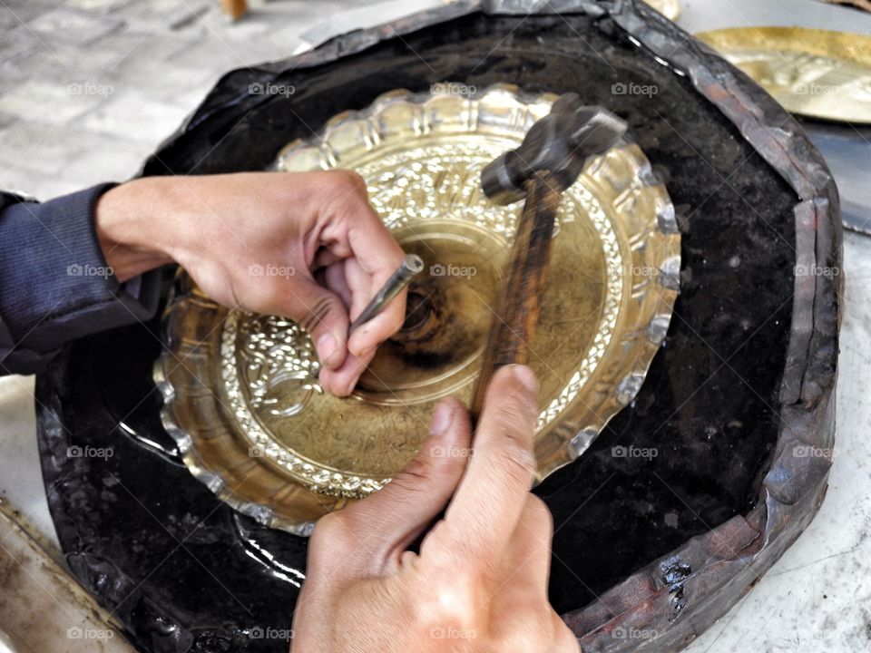 I came closer and took this pictures of a man who making that plate. He was so concentrated that he didn't notice me standing there.
