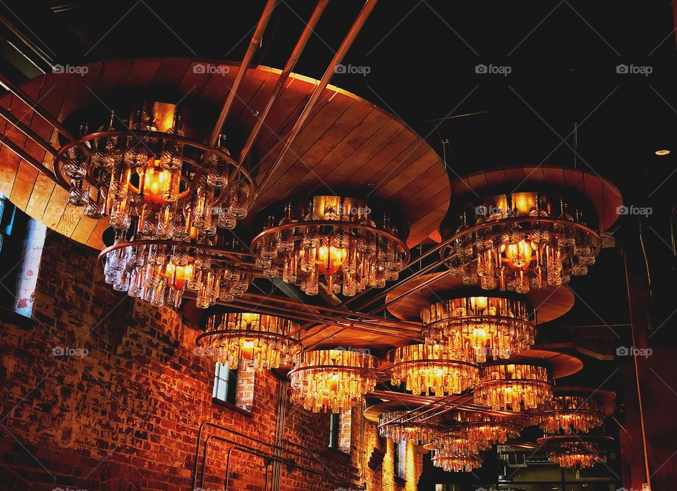 This collection of lights are taken from a distillery in the Distillery District in Toronto. A beautiful contrast of love amber and dark brown light give this photo a home bound effect. Would be great for a relaxed setting.