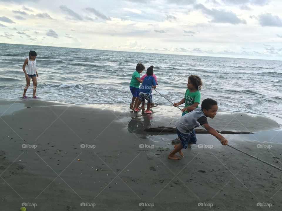 Kids pulling a fishing net