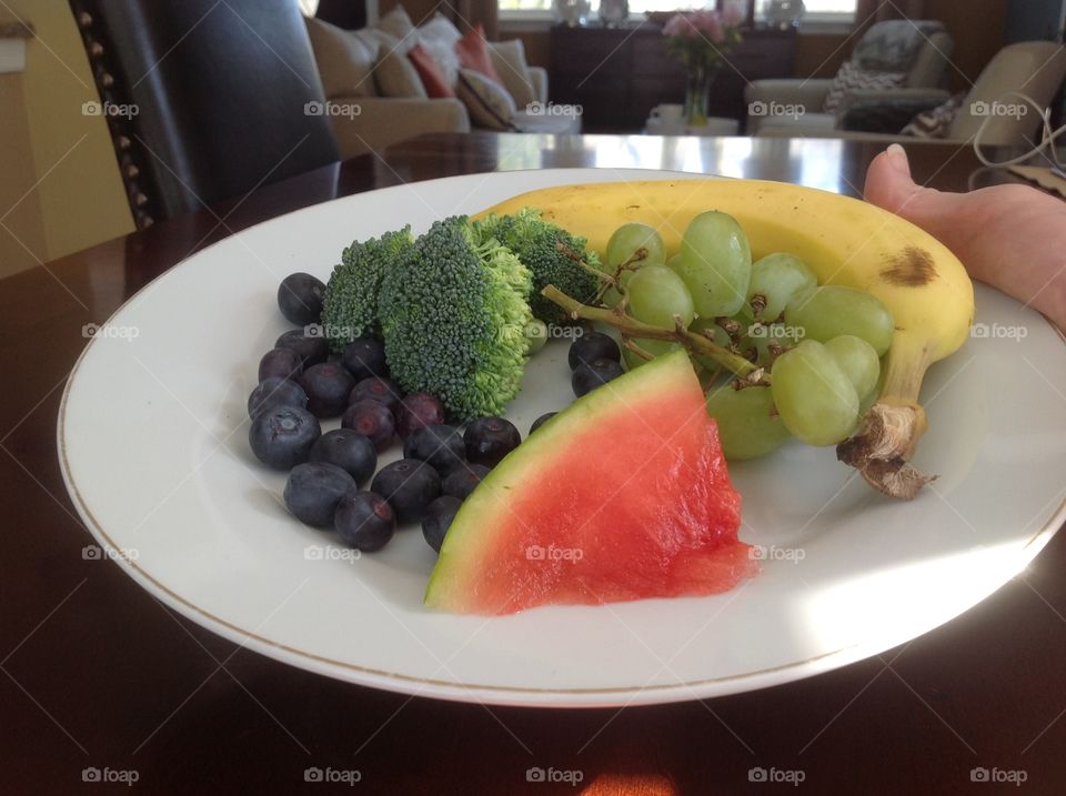 Colorful plate of fruits and vegetables that are good for you.