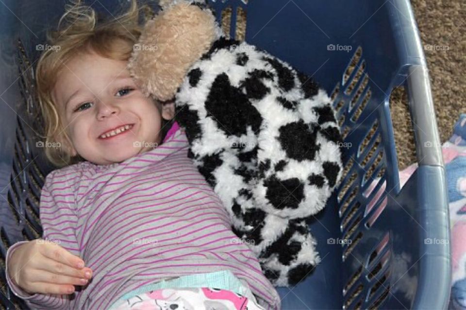 Smiling girl lying in basket