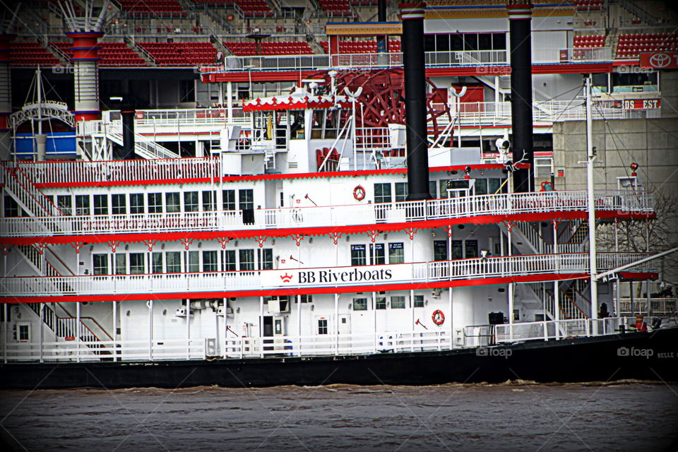 This is a red and white riverboat docked on the Ohio River in Newport Kentucky by the Newport Aquarium.