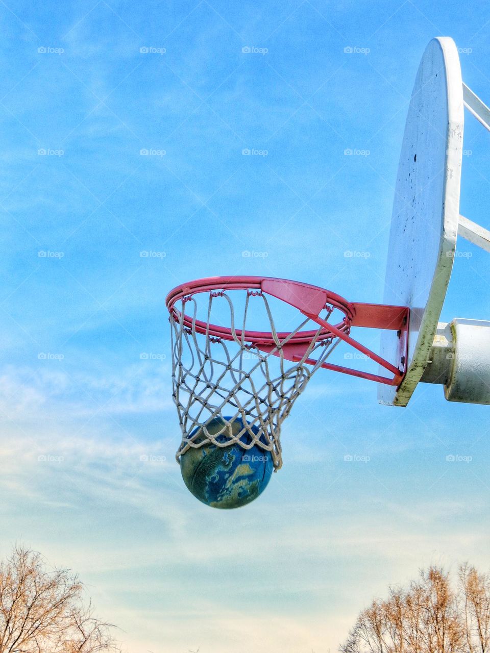 Basketball dropping through the hoop.