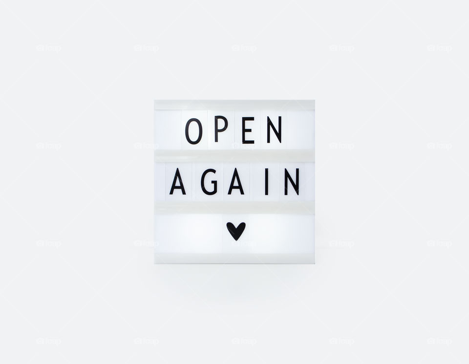 Open again lettering on a light box 