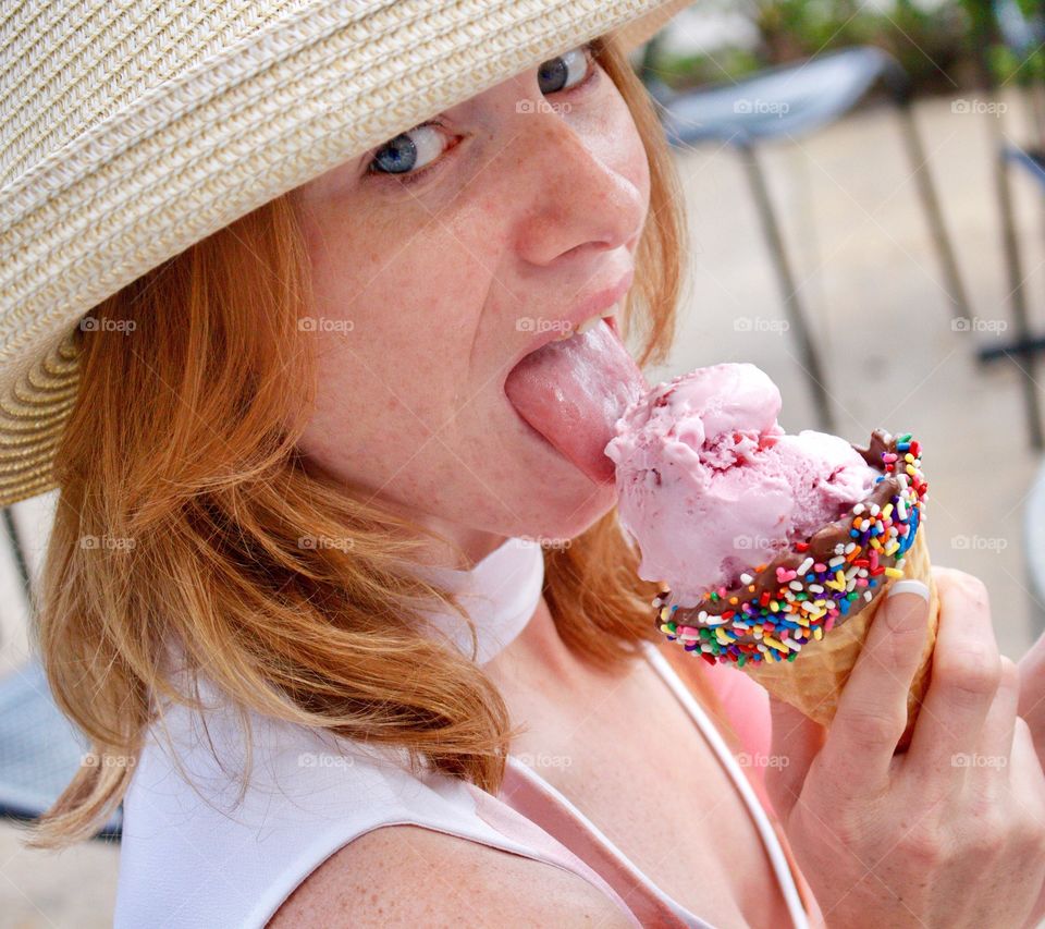 Eating a pink strawberry Icecream waffle cone dipped in chocolate and sprinkles 🍦