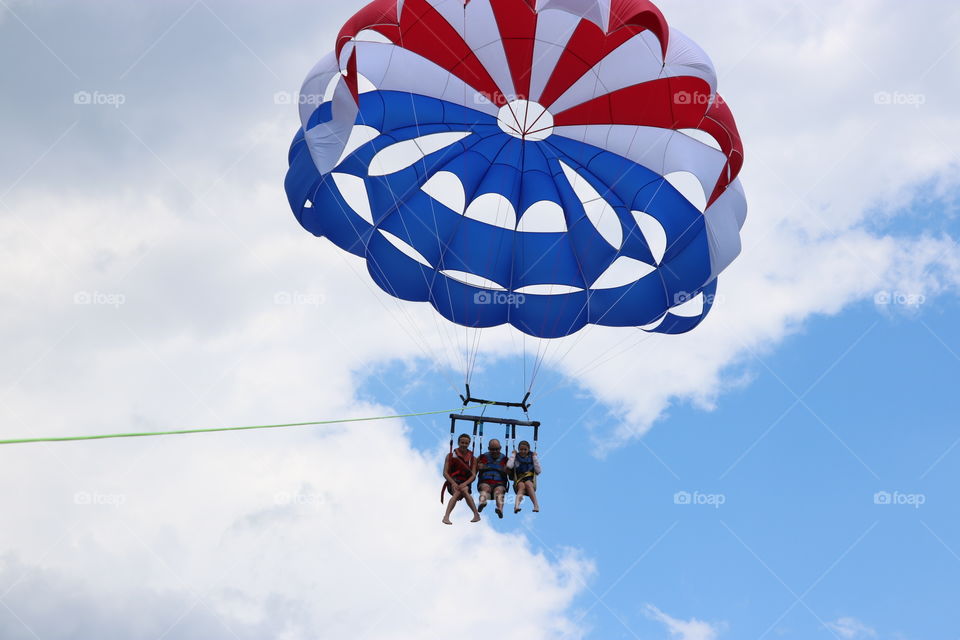 Three Parasailing together red, white and blue