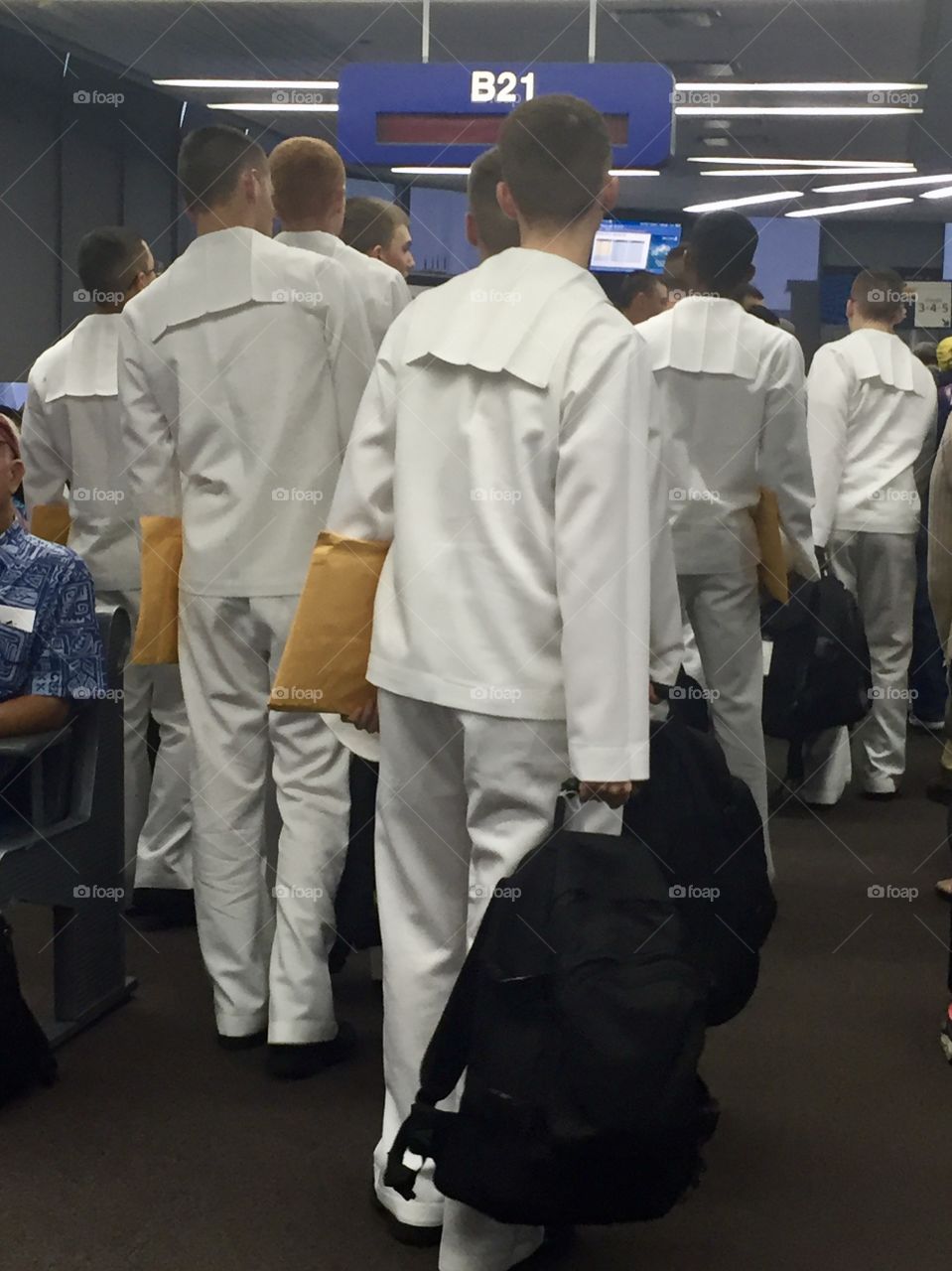 Navy seamen with orders in hand boarding an airplane 