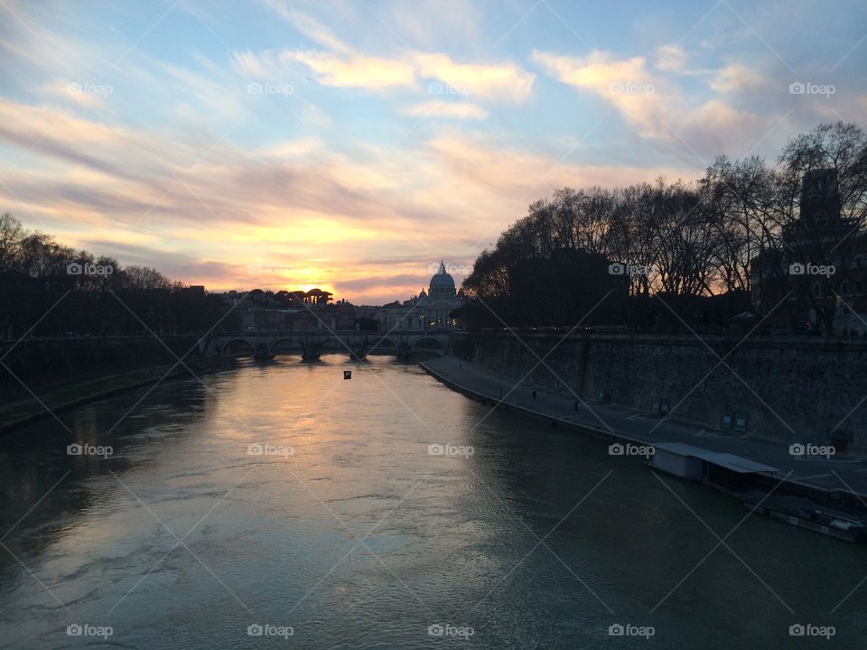 Sunset in Rome. Sunset on Roman bridge overlooking St. Peter's Basilica and the Vatican
