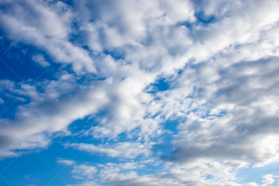 The beauty of the sky with clouds and the sun.